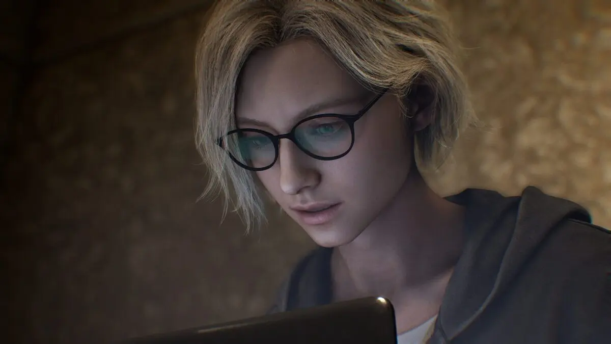 Young woman with glasses using laptop in dim light