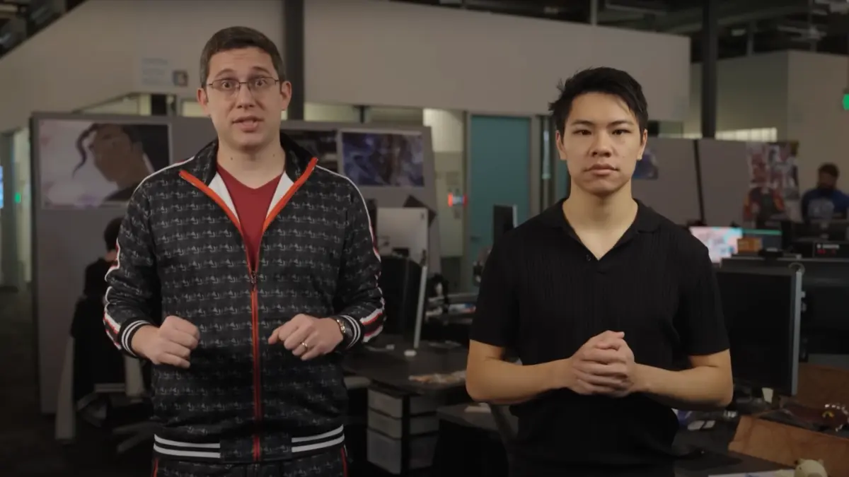 Two people standing in a modern office.
