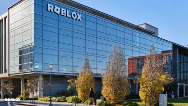 Modern building with glass facade and trees outside.