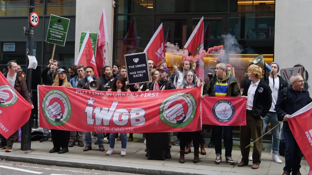 Workers protesting with union banners and signs