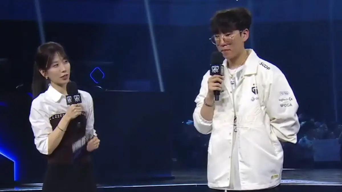 Esports interviewer speaks with player on blue-lit stage