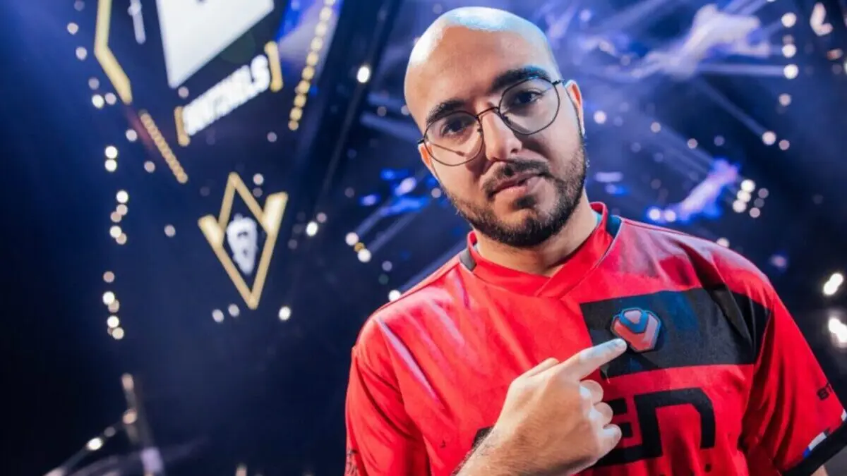 Esports player pointing to logo on red jersey