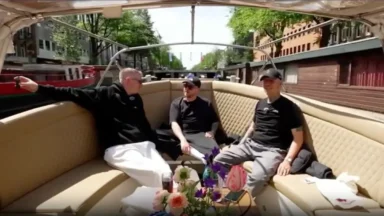 Three men relaxing on canal boat ride