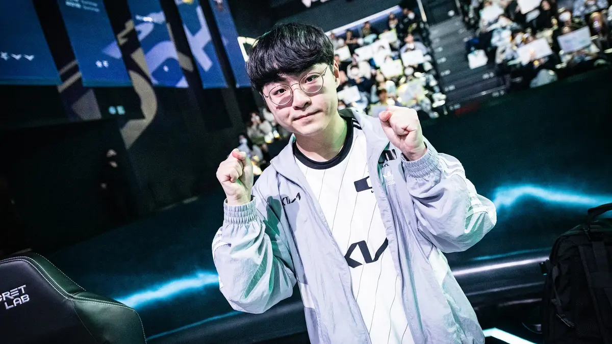 Esports player celebrates with raised fists on stage