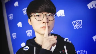 Man with glasses making shushing gesture