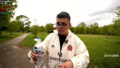 Person holding water bottle in park livestream