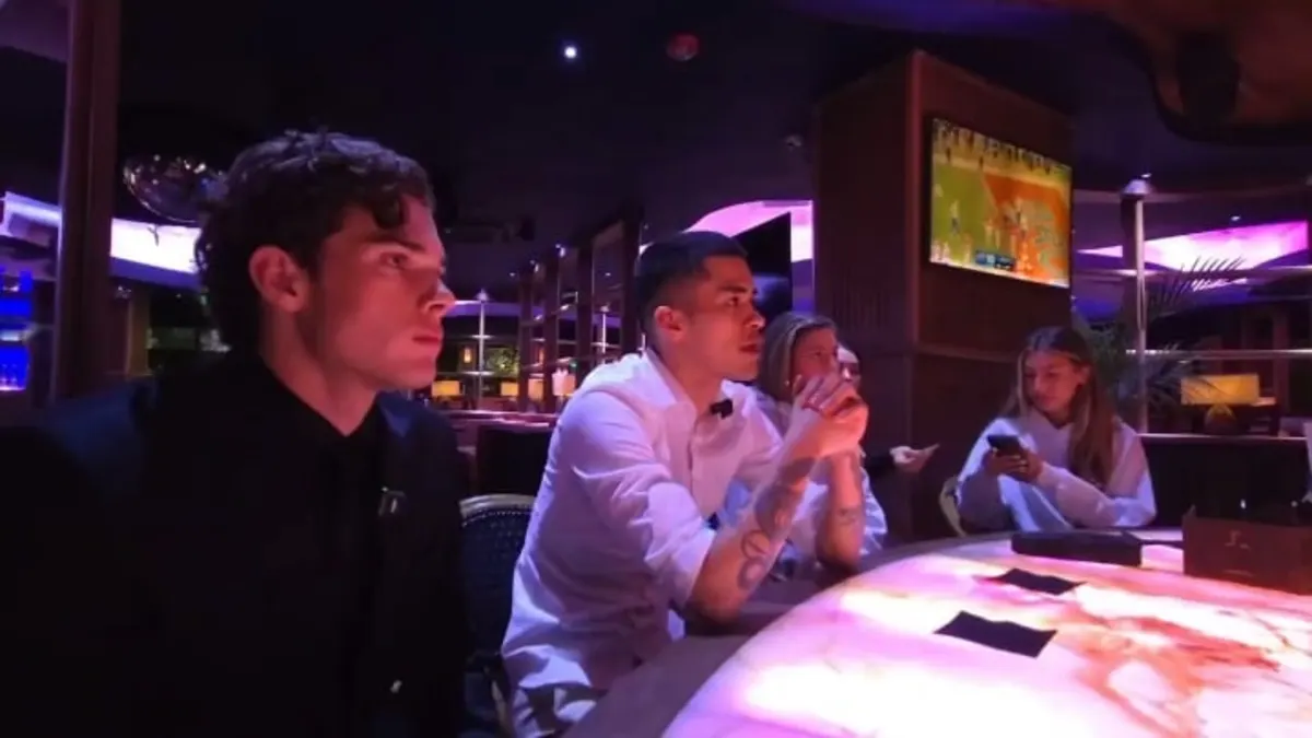 Group watching sports at neon-lit lounge table