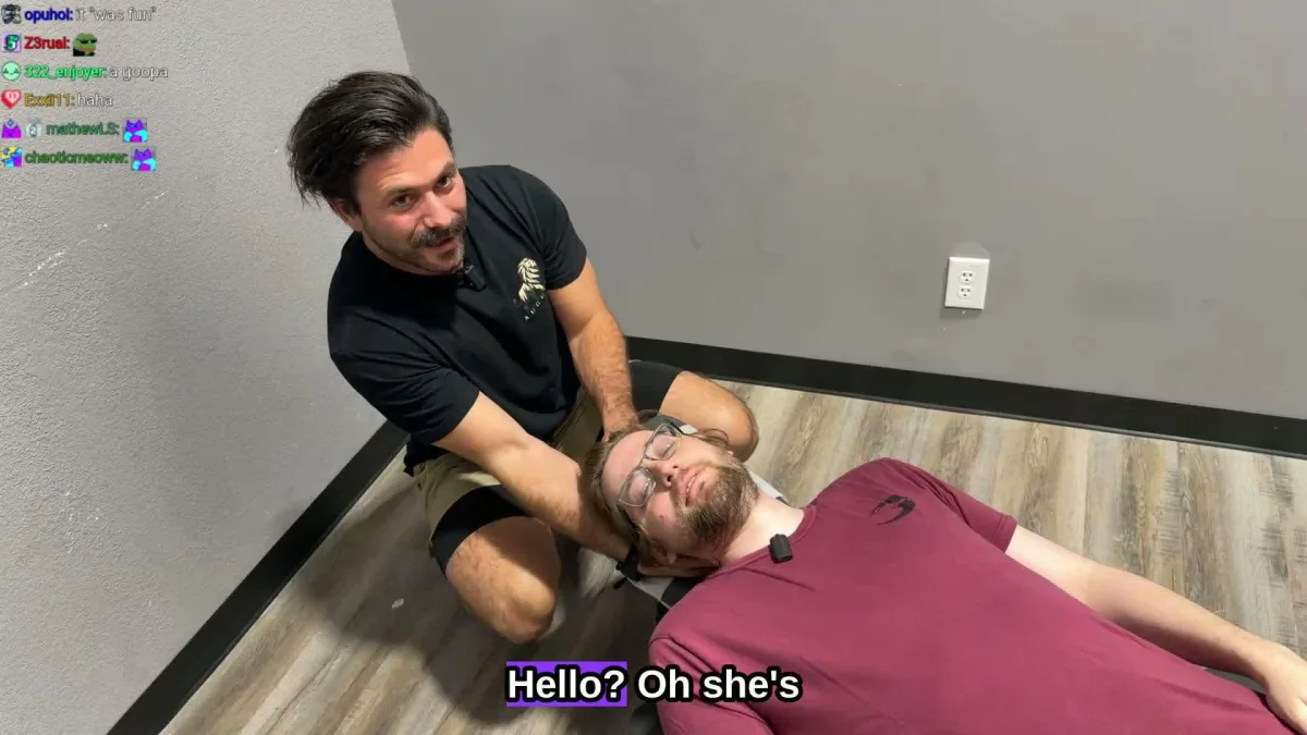 Man performing neck adjustment on man lying down