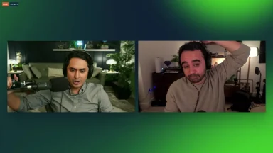Two men podcasting with microphones in room.