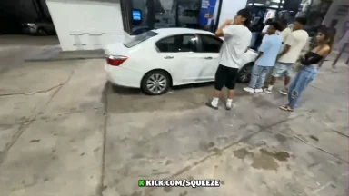 People gathered around white car at gas station