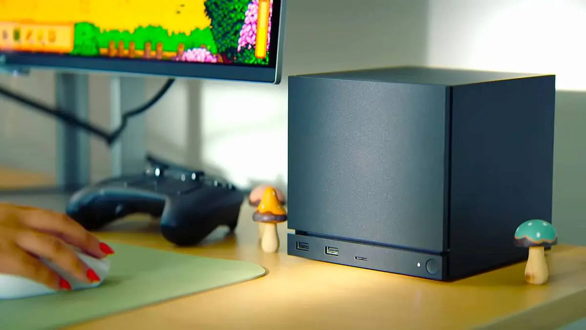 Compact gaming PC beside monitor and controller