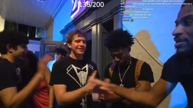 Young men greeting each other at indoor party