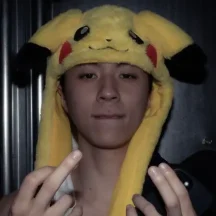Person wearing Pikachu hat posing indoors
