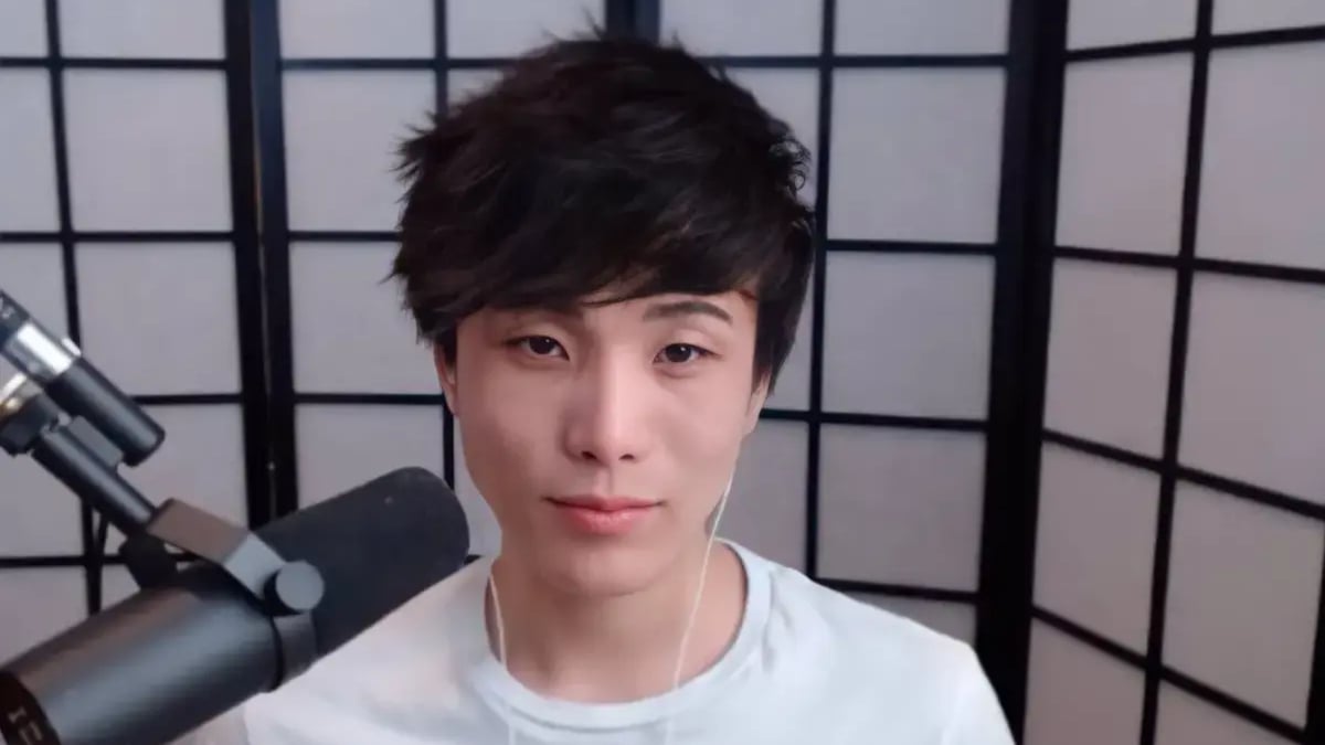 Person speaking into microphone with folding screen backdrop