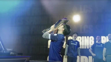 Esports player kisses championship trophy on stage