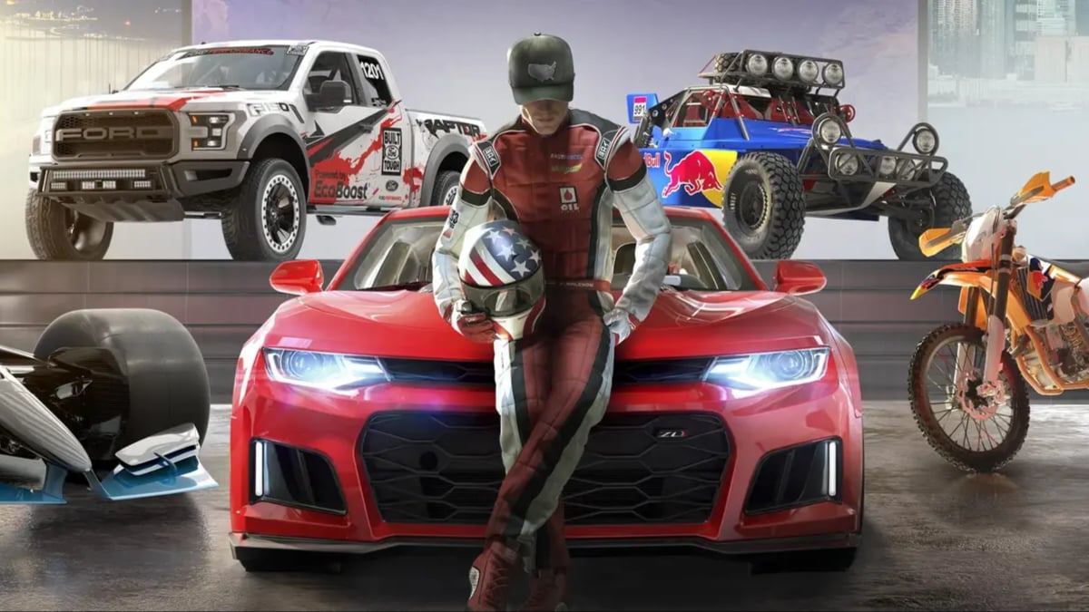 Race driver leaning on red sports car