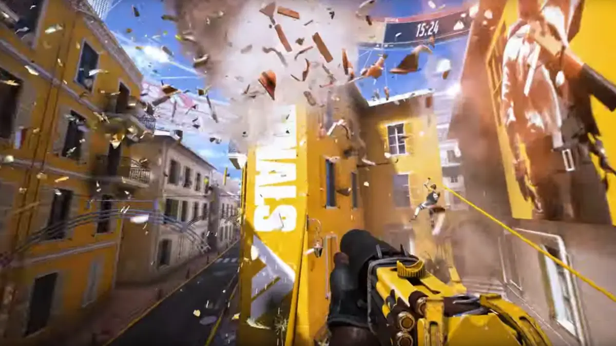 First-person shooter scene with yellow gun amid exploding city buildings.