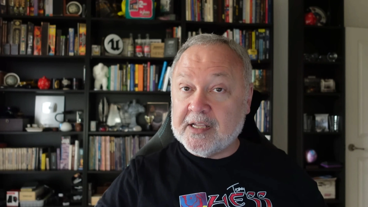 Person speaking in front of bookshelf background