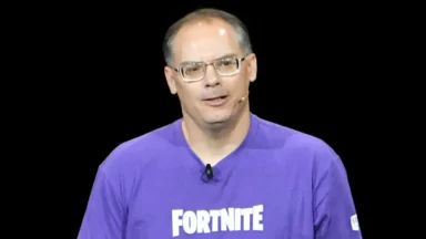 Man wearing Fortnite shirt speaking on stage