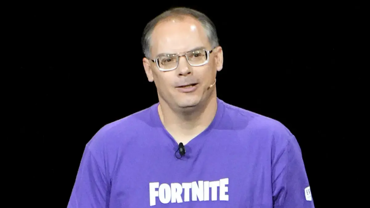 Man wearing Fortnite shirt speaking on stage