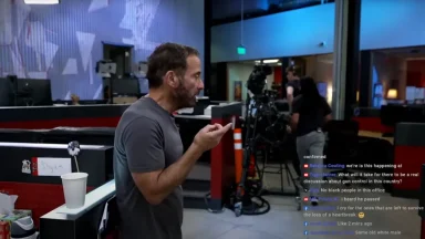 Man in office with camera setup, livestream comments visible.