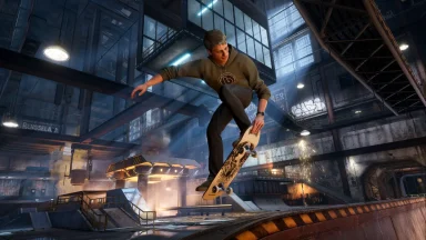 Skateboarder performing trick in indoor skate park.