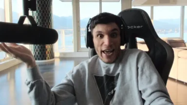 Man with headset speaking into large microphone indoors