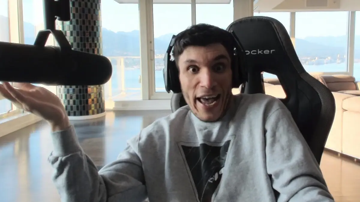 Man with headset speaking into large microphone indoors