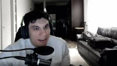Person speaking into microphone at home setup