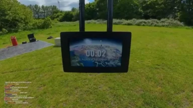 Outdoor suspended screen displaying countdown over grassy field