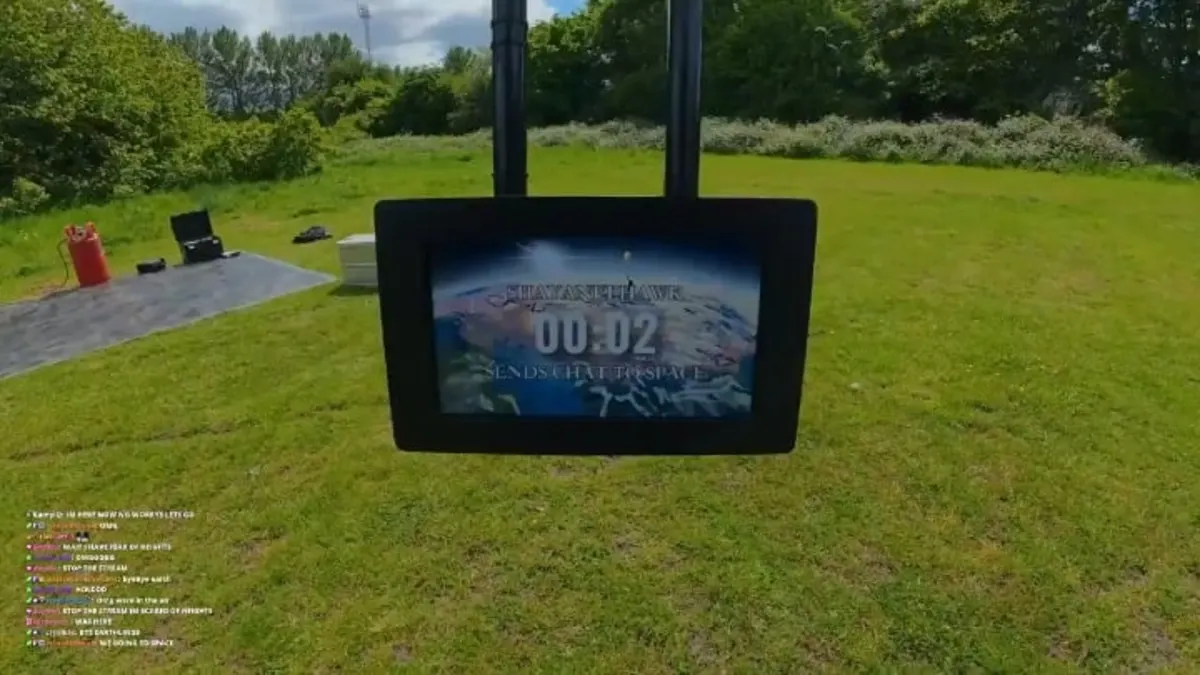 Outdoor suspended screen displaying countdown over grassy field