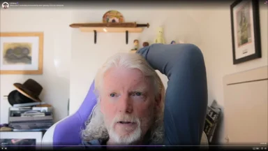 Older man with white hair in home office