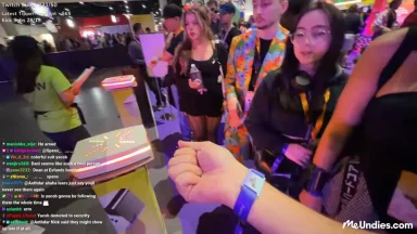 People interacting at a gaming convention booth