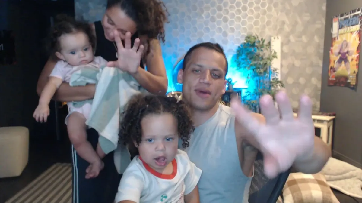 Family waving at camera in cozy living room
