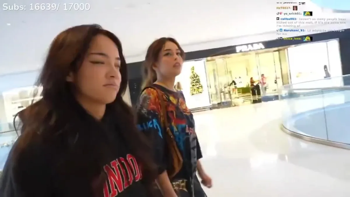 Two women walking inside a shopping mall.