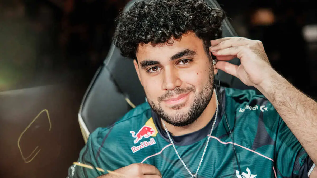 Esports player adjusts headset while seated in gaming chair