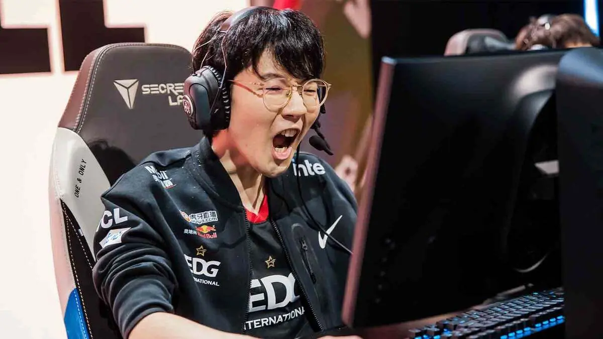 Excited esports player wearing headset at computer