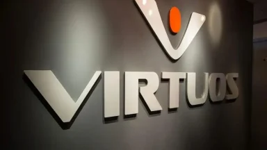 Virtuos company wall logo with orange dot.