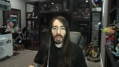 Person streaming in room with collectibles display.