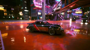 Sports car on wet neon city street