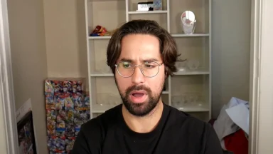 Man with glasses reacting in a home office