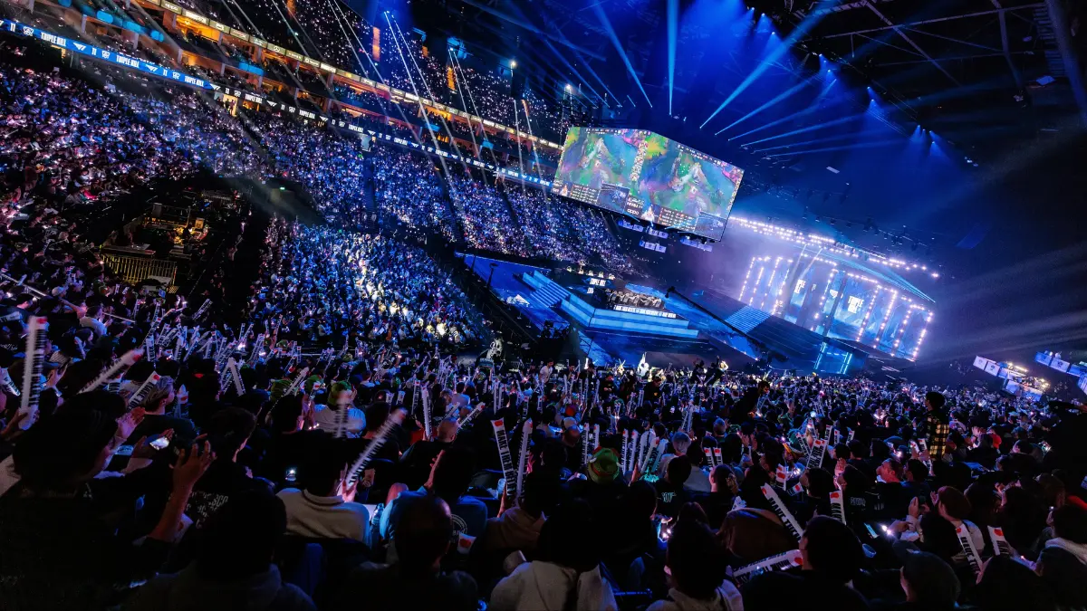 Crowded esports arena with large stage and screens