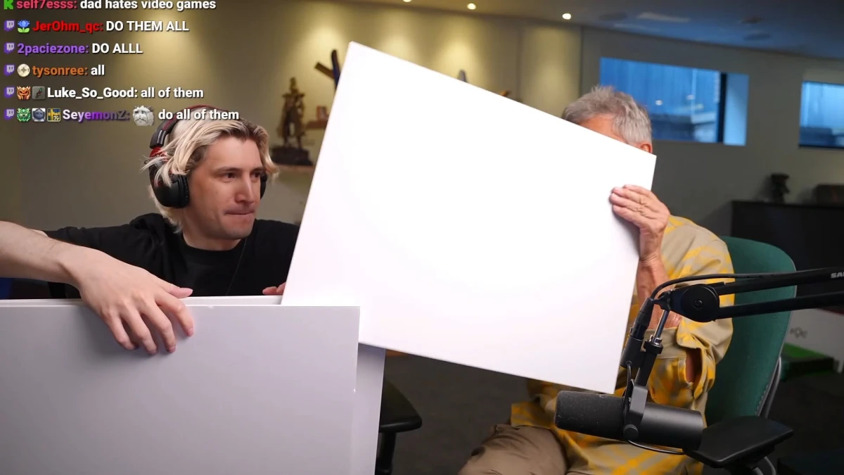 Two men hold blank boards during livestream recording