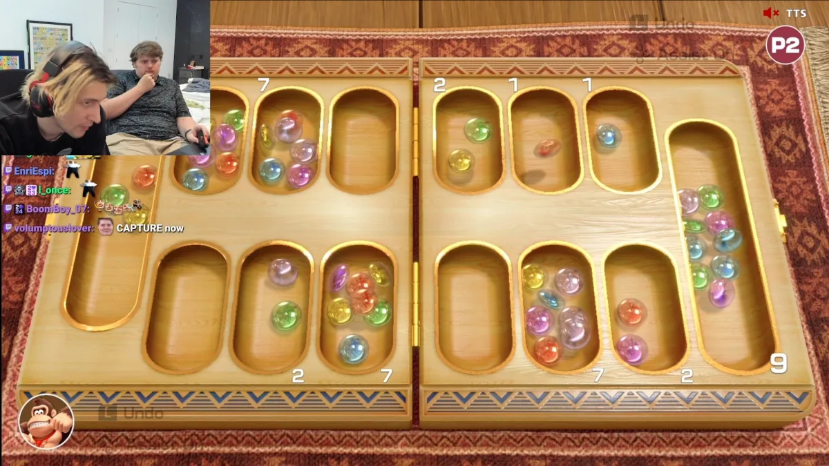 Wooden mancala board with colorful marbles and scores