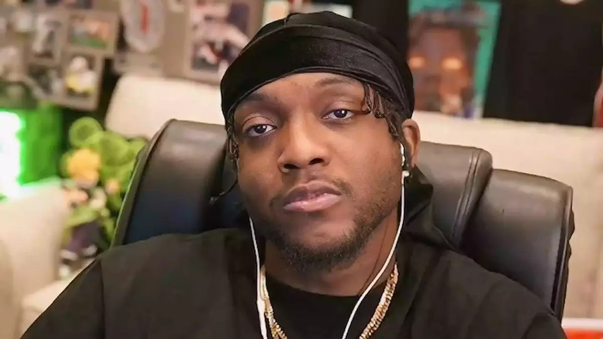 Man wearing black durag and earphones indoors