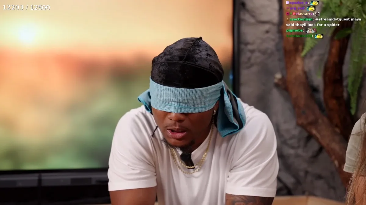 Man with blindfold in nature setting.