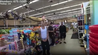 Three men standing inside a grocery store aisle