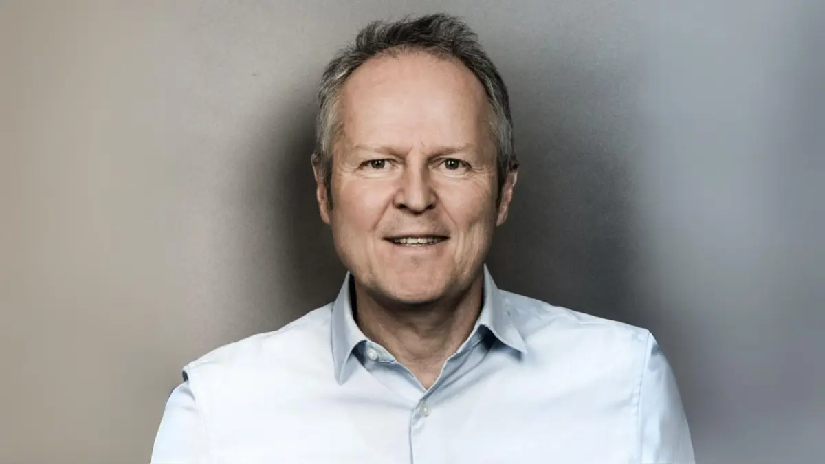 Smiling man in light blue shirt