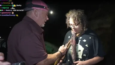 Man showing large fish to woman at night