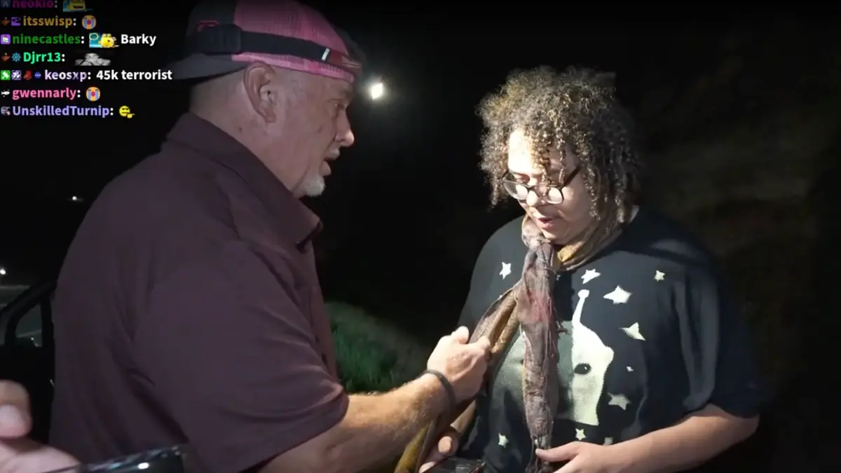 Man showing large fish to woman at night